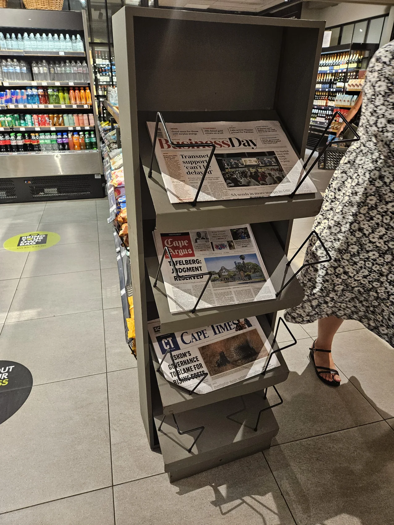 Freestanding metal magazine rack in a retail store